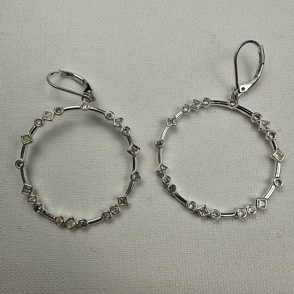 Silver hoop earring with clasp closure. Small faux diamonds. Dangle.